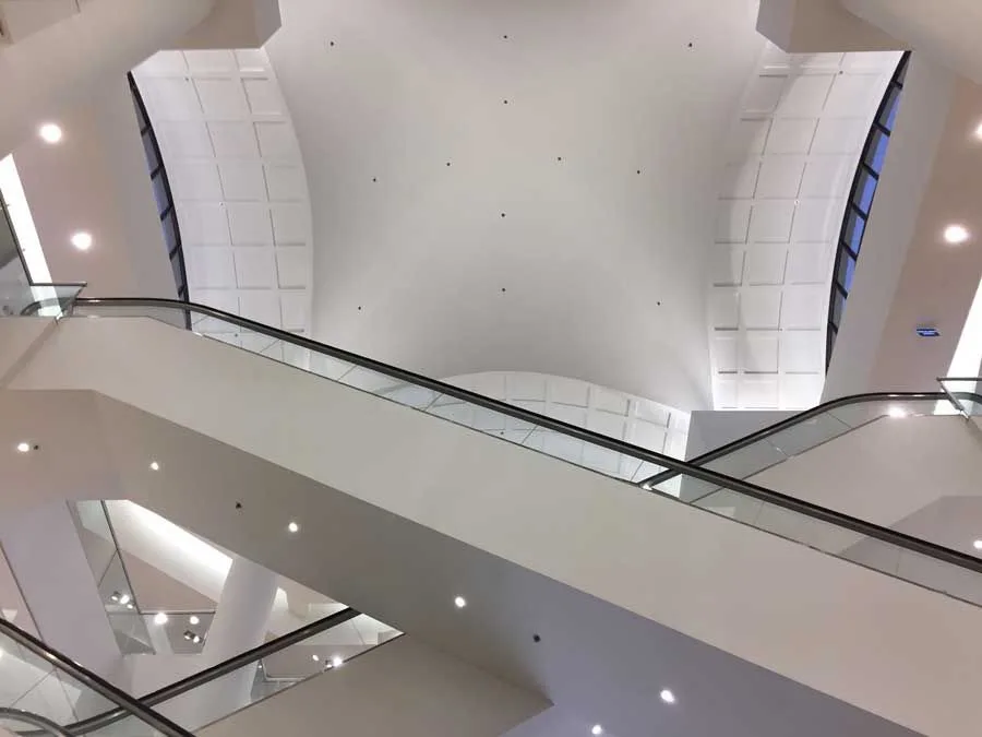 Looking up at the ceiling of an escalator in a building